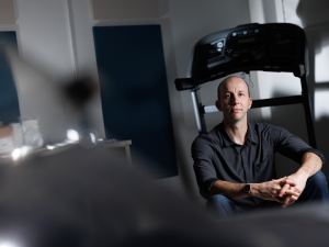 Herman Pontzer sitting on a treadmill in his lab